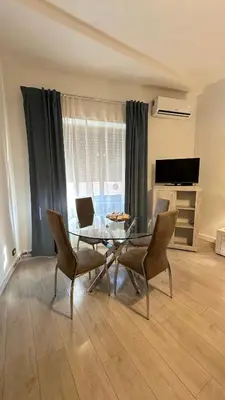 a living room with a glass table and chairs at Vatican YH in Rome