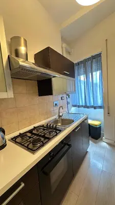 a kitchen with a sink and a stove top oven at Vatican YH in Rome