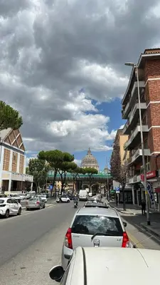 a street with cars parked on the side of the road at Vatican YH in Rome