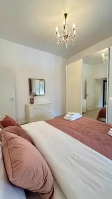 a bedroom with a large bed and a chandelier at Vatican YH in Rome