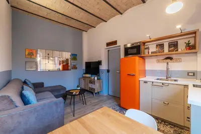 a living room with a couch and a kitchen at Orti Apartment - Charme Holidays in Rome