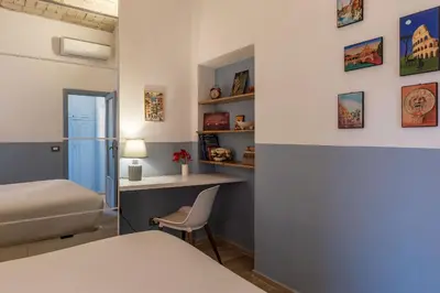 a bedroom with a bed and a desk and a chair at Orti Apartment - Charme Holidays in Rome