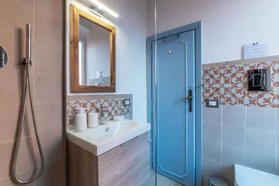 a bathroom with a sink and a shower with a mirror at Orti Apartment - Charme Holidays in Rome