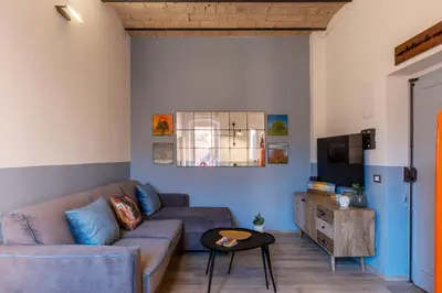 a living room with a couch and a tv at Orti Apartment - Charme Holidays in Rome