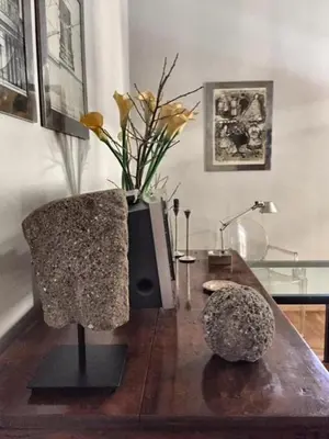 a living room with a table with a vase of flowers at San LoFt in Rome