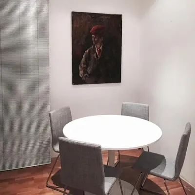 a dining room with a table and a painting of a man at San LoFt in Rome