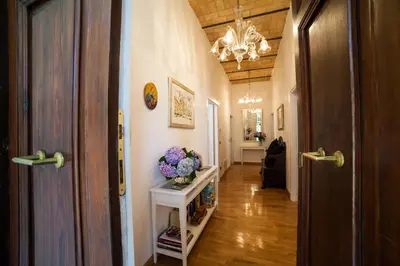 a hallway of a home with a door and flowers on a table at Villa Paganini B&B in Rome