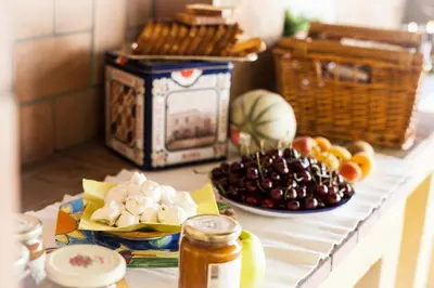 a table topped with fruit and a jar of honey at Villa Paganini B&B in Rome