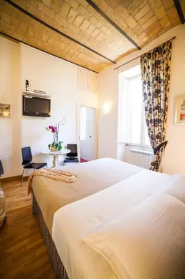 a hotel room with two beds and a window at Villa Paganini B&B in Rome