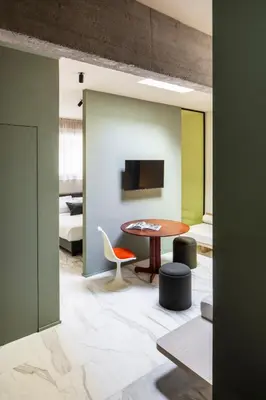 a room with a table and chairs and a bedroom at ATEL Guest House in Rome