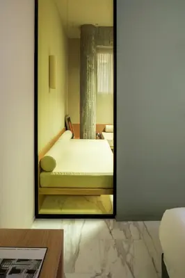 a mirror reflection of a bed in a room at ATEL Guest House in Rome