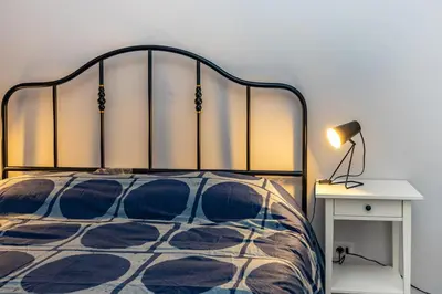 a bedroom with a bed with a lamp and a table at La Dimora di Margot in Rome