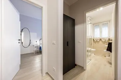 a hallway with a black door and a bathroom at La Dimora di Margot in Rome
