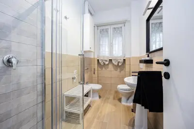 a bathroom with a toilet and a sink and a shower at La Dimora di Margot in Rome