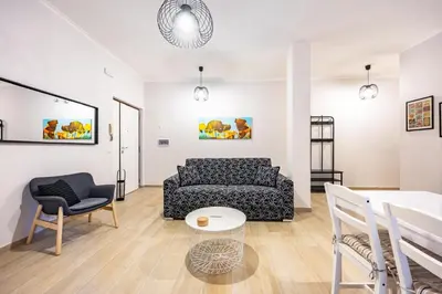 a living room with a couch and a table at La Dimora di Margot in Rome
