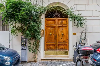 a wooden door on a building with ivy at Bibi Home - Vaticano in Rome