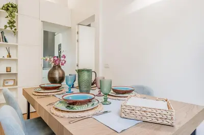 a dining room table with plates and bowls on it at Bibi Home - Vaticano in Rome