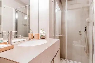 a white bathroom with a sink and a shower at Bibi Home - Vaticano in Rome