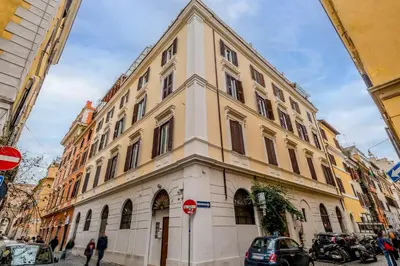 a large building on a city street with a stop sign at Bibi Home - Vaticano in Rome