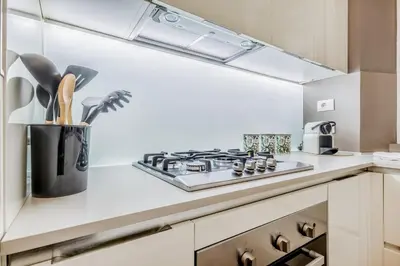 a kitchen with a stove top oven next to a counter at Bibi Home - Vaticano in Rome