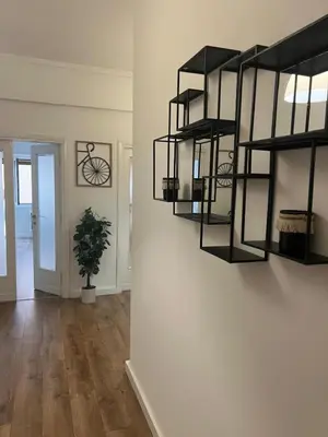 a living room with black shelves on a wall at Casa da favola Roma in Rome
