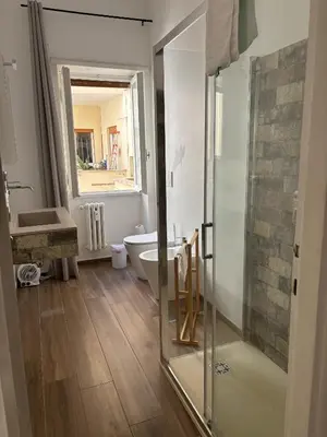 a bathroom with a glass shower and a tub at Casa da favola Roma in Rome