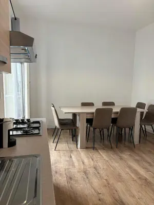 a kitchen and dining room with a table and chairs at Casa da favola Roma in Rome