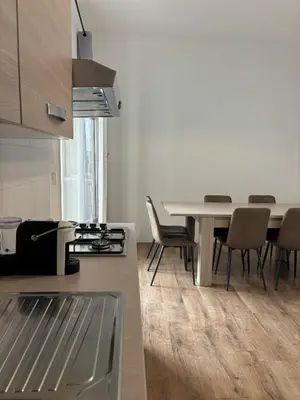 a kitchen and dining room with a table and chairs at Casa da favola Roma in Rome