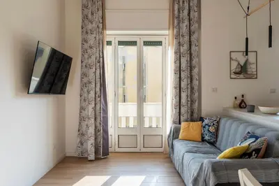a living room with a couch and a sliding glass door at GuestHost - RM Veio 52B in Rome