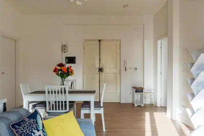 a living room with a table and a blue couch at GuestHost - RM Veio 52B in Rome