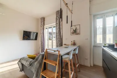 a kitchen and living room with a table and a couch at GuestHost - RM Veio 52B in Rome