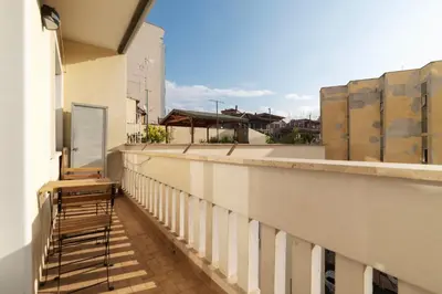a balcony with a chair on the side of a building at GuestHost - RM Veio 52B in Rome