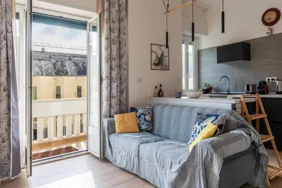 a living room with a couch and a kitchen at GuestHost - RM Veio 52B in Rome