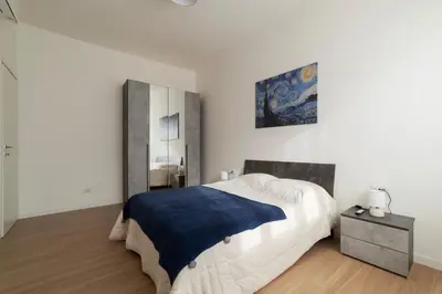 a bedroom with a large bed and a mirror at GuestHost - RM Veio 52B in Rome