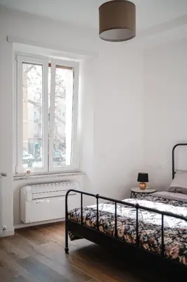 a bedroom with a bed and a window at Domus Iulia, Trastevere in Rome