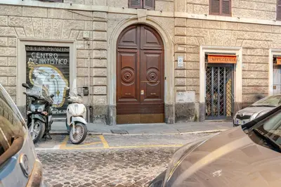 a motorcycle parked in front of a building at Luxe Escape Colosseo in Rome