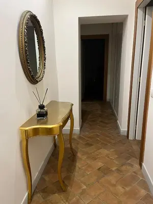 a gold table with a mirror on a wall at Deluxe Spanish Steps in Rome