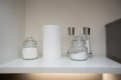 two glass jars sitting on a white shelf at Deluxe Spanish Steps in Rome