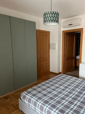 a bedroom with a bed with a checkered blanket at Daniela Luxury Apartment in Rome