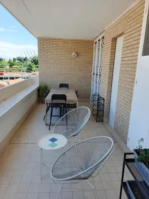 a patio with two chairs and a table on a balcony at Daniela Luxury Apartment in Rome