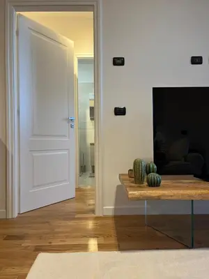 a door leading into a living room with a table at Daniela Luxury Apartment in Rome