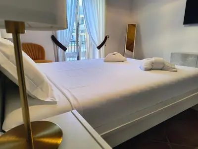 a bed with two pillows on it in a room at The Apartment in Rome