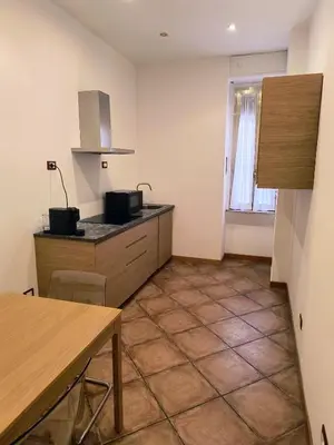 a kitchen with a table and a counter top at The Apartment in Rome
