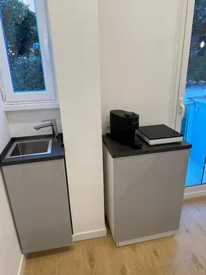 a kitchen with a sink and a counter with a sink at Maryam Vatican Suites in Rome