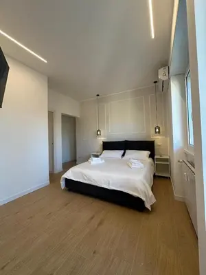 a bedroom with a large bed with white sheets at Maryam Vatican Suites in Rome
