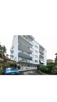 a white building with a blue car in front of it at Maryam Vatican Suites in Rome
