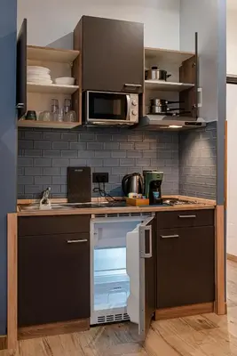 a kitchen with a table and stools in a room at Helle Hus - 4 min to Metro, Modern & Quiet, Direct to Colosseum in Rome