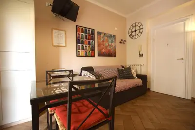 a living room with a couch and a table at Margherita Holiday Home in Rome