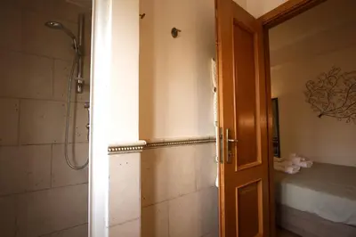 an open door to a bathroom with a shower at Margherita Holiday Home in Rome