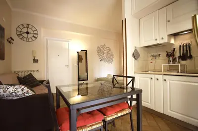 a kitchen with a glass table in a room at Margherita Holiday Home in Rome